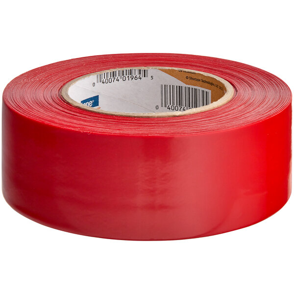 A roll of red Shurtape PE 444 UV-resistant stucco masking tape.