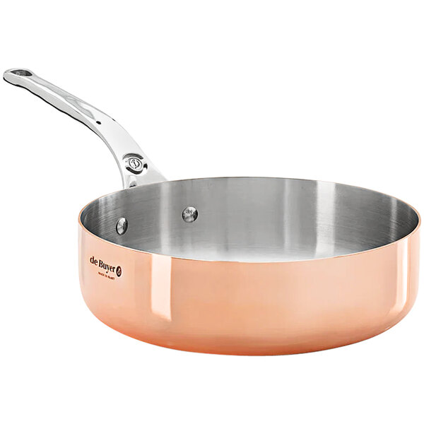 A de Buyer copper saute pan with a handle and lid.
