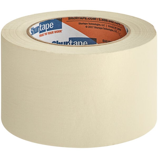A roll of Shurtape natural utility grade masking tape with a blue label.