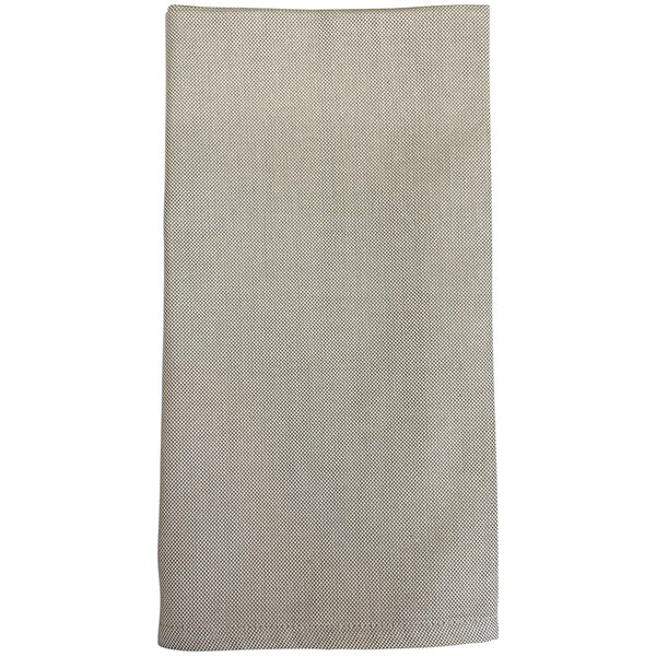 A close-up of a plain beige Garnier-Thiebaut cloth napkin.