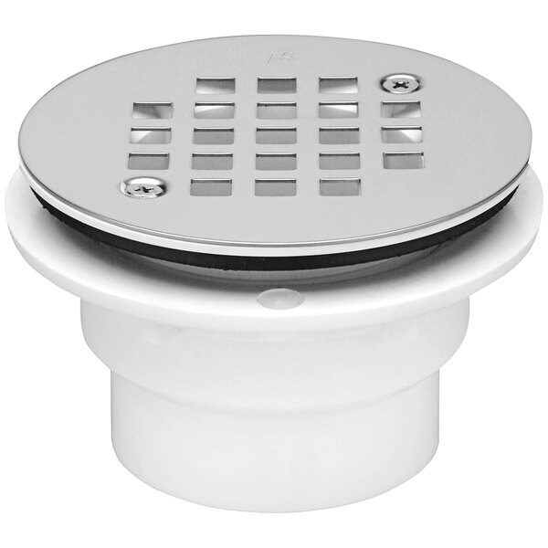 A white Zurn PVC floor drain with a round stainless steel cover.
