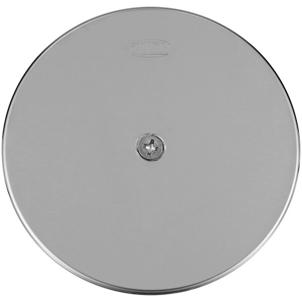 A silver circular stainless steel access cover with a screw in the center.