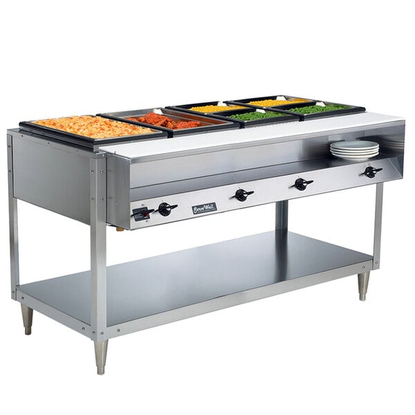 A Vollrath ServeWell electric hot food table with food trays on a table.