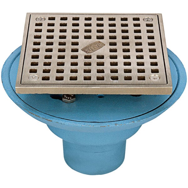A Zurn cast iron floor drain with a square nickel bronze grate.