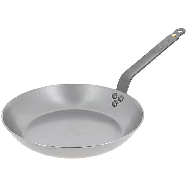 A close-up of a de Buyer Mineral B Element carbon steel frying pan with a handle.