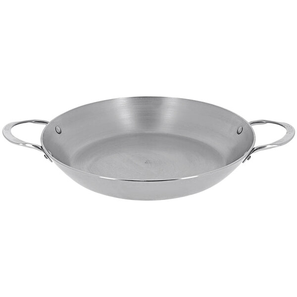 A silver de Buyer carbon steel paella pan with handles.