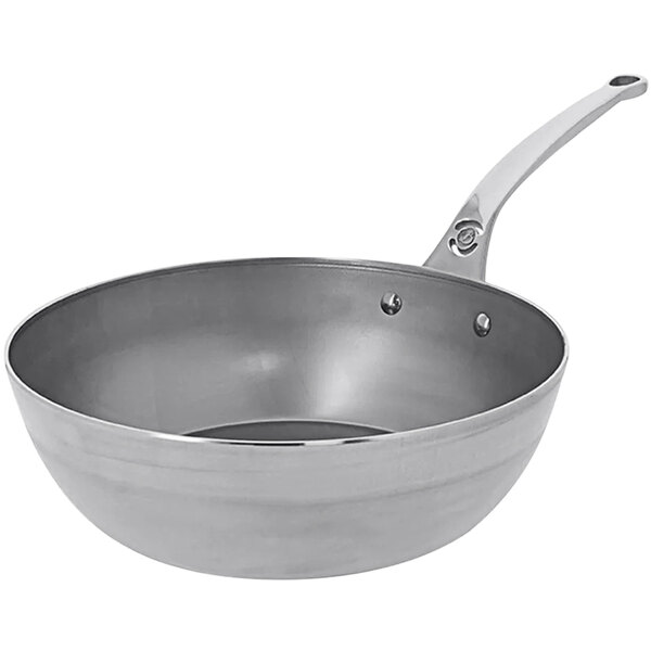 A de Buyer carbon steel frying pan with a silver handle.