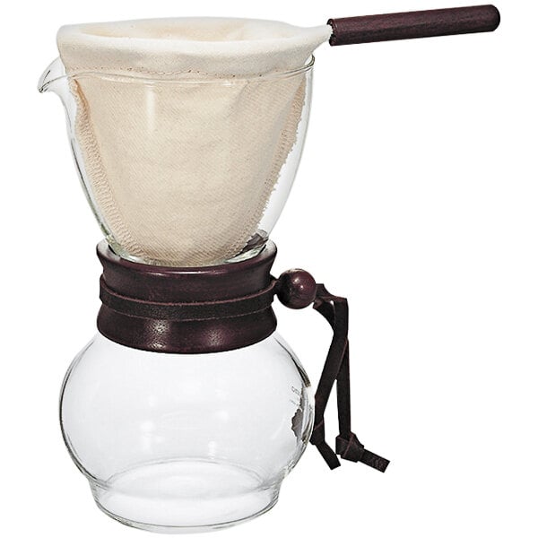 A Hario glass coffee maker with a wooden neck and cloth filter.
