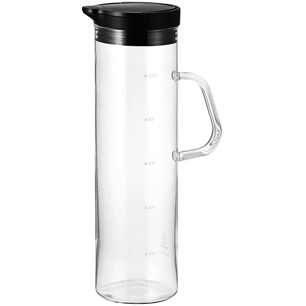 A clear glass pitcher with a closeable black lid.