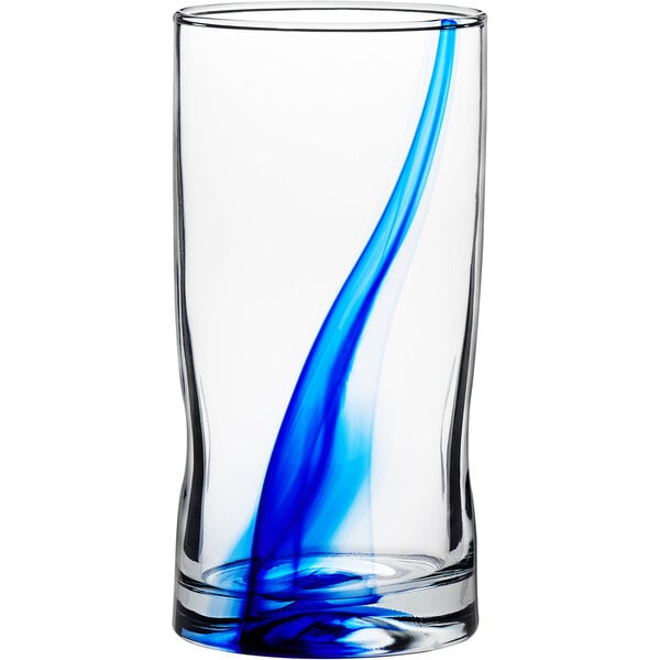 A Libbey cooler glass with blue and white swirls filled with blue liquid.