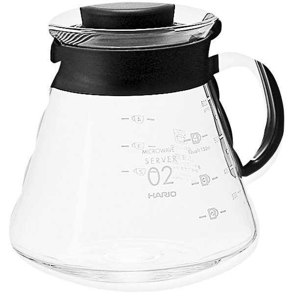 A Hario glass coffee server with a black handle.