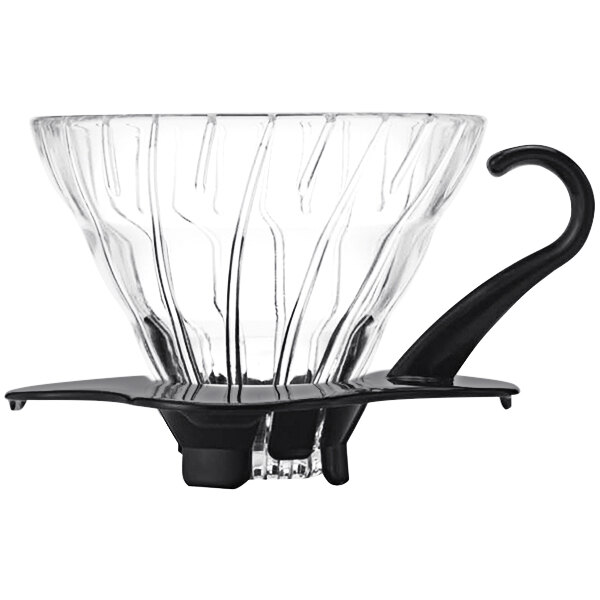 A clear glass dripper with a black handle.