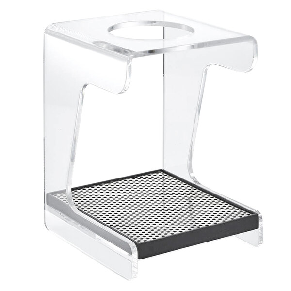 A clear plastic Hario V60 dripper stand with a metal surface and a hole.