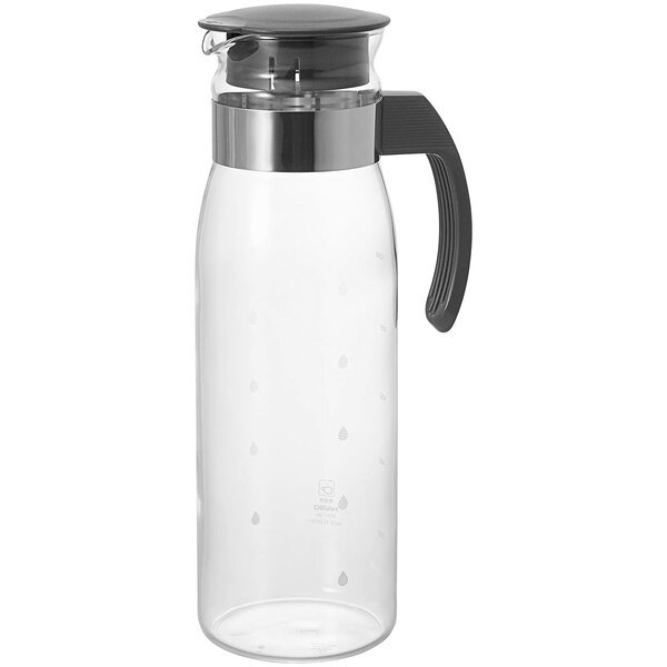 A clear glass pitcher with a black handle and lid.