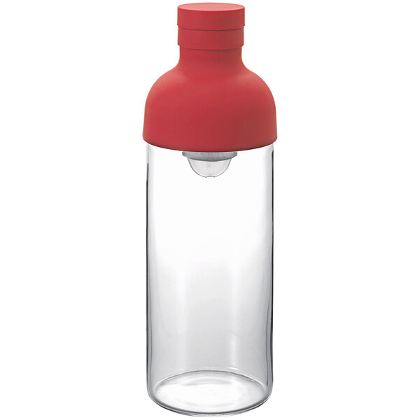 A clear glass container with a red lid.