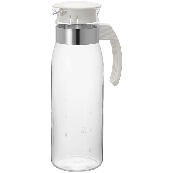 A clear glass pitcher with a white lid and handle.