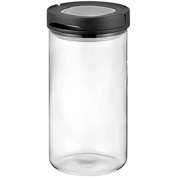 A clear glass Hario canister with a black lid.