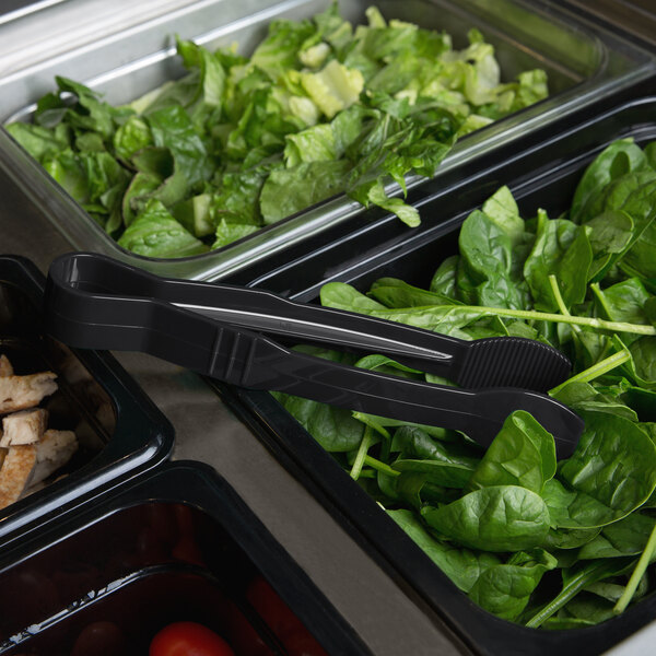 A tray of salad with Thunder Group Black Polycarbonate Flat Grip Tongs.