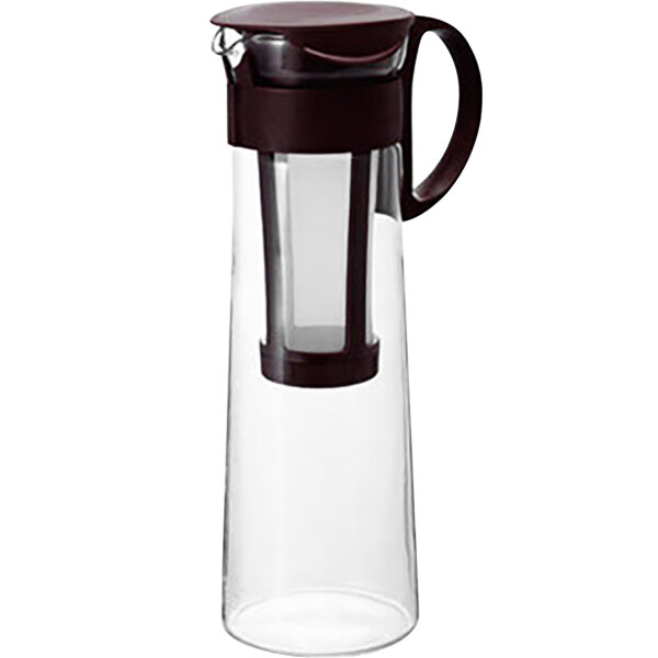 A Hario glass water pitcher with a brown lid.