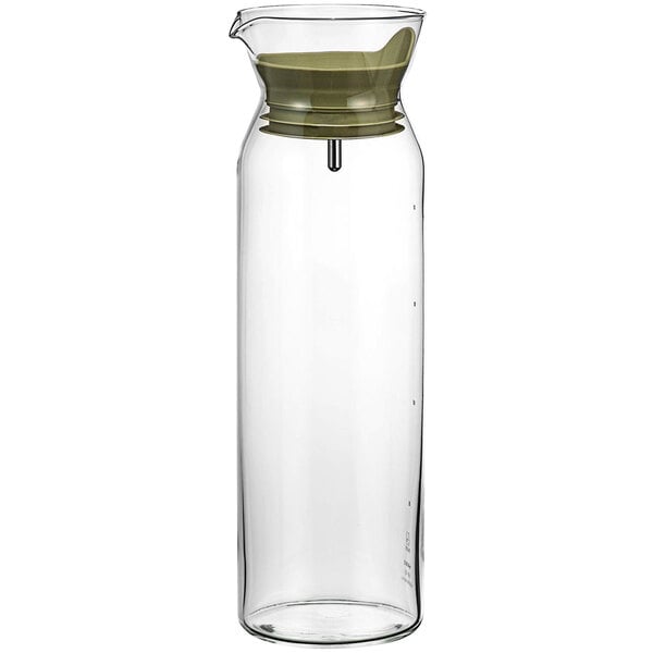 A glass water pitcher with a smoky green lid.