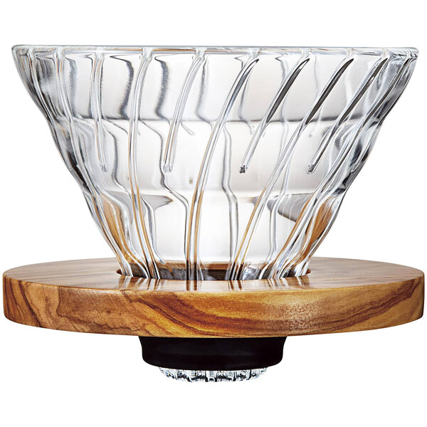 A Hario glass and wood coffee dripper in a wood base.