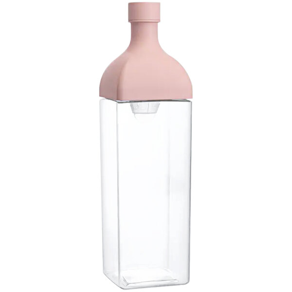 A close-up of a plastic bottle with a pink lid.