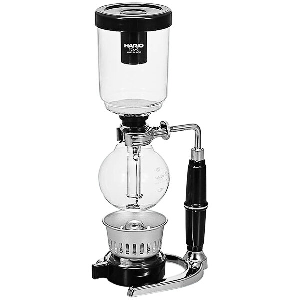A Hario Technica coffee syphon in a metal and glass stand.
