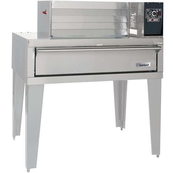 A large stainless steel Garland pizza deck oven with a top-mounted power module.