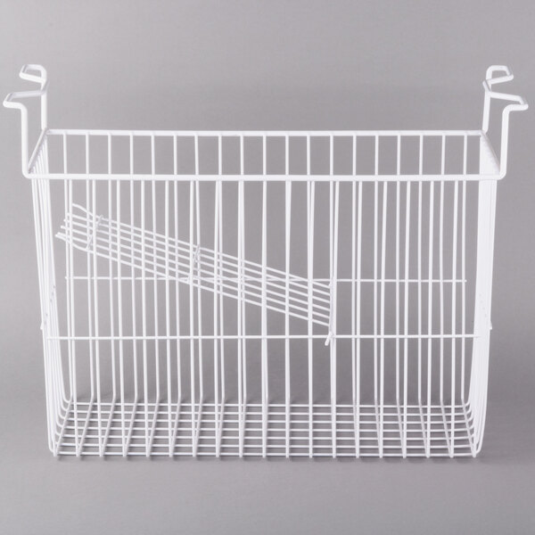 A white wire basket with a handle hanging inside a white freezer.