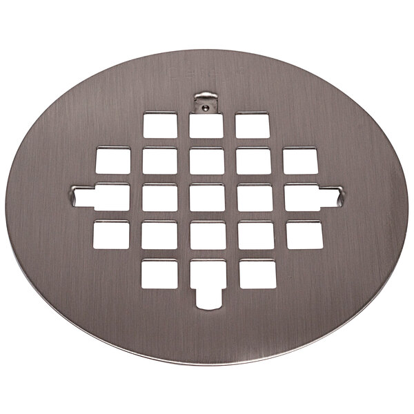 A circular metal Oatey shower drain strainer with holes.
