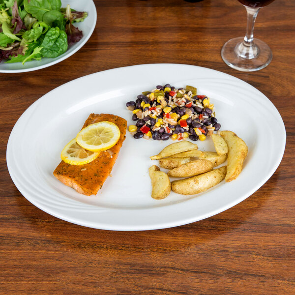 A CAC Porcelain Platter with salmon, potatoes, and salad on it.