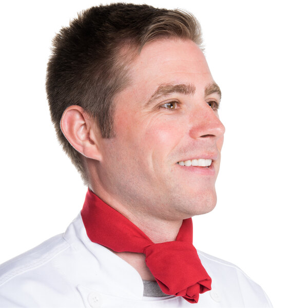 A man wearing a red neckerchief around his neck.
