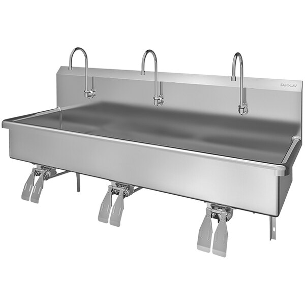 A large stainless steel Sani-Lav wall mounted multi-station sink with 3 knee-operated faucets.