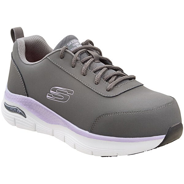 A grey Skechers athletic shoe with purple accents and a white sole.