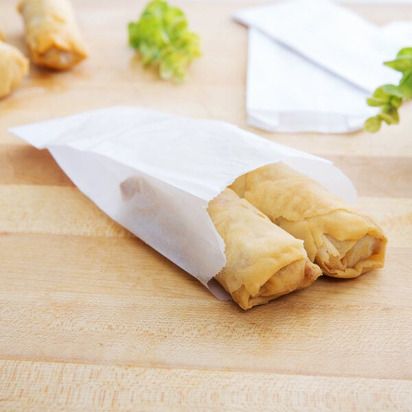 A Kari-Out Company glassine paper bag filled with spring rolls.