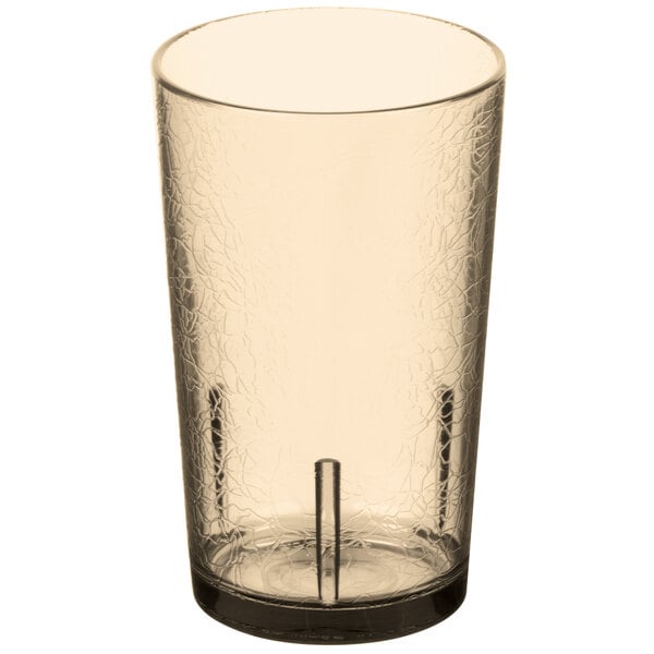 A close-up of a light amber Cambro plastic tumbler with a crackled surface.