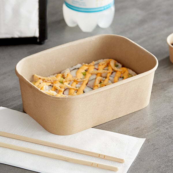 A rectangular Kraft paper take-out container with sushi inside on a table.
