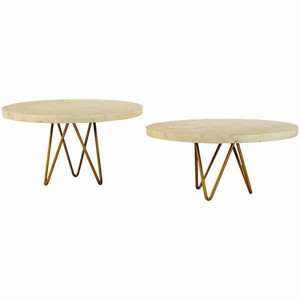 A pair of round white marble display stands with brass bases.