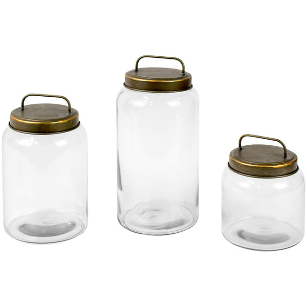A group of clear glass jars with metal lids.