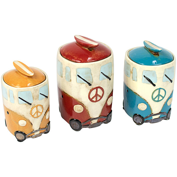 A group of ceramic containers shaped like VW buses with peace signs on them.