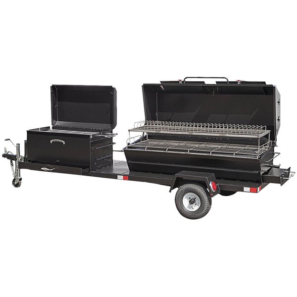 A black Meadow Creek Caterer's Delight BBQ pit and chicken cooker on a trailer with a shelf.