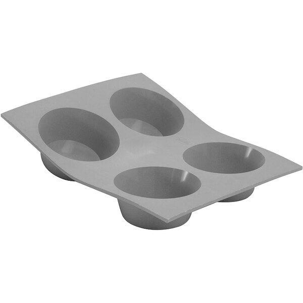 A gray silicone baking mold with four muffin compartments.