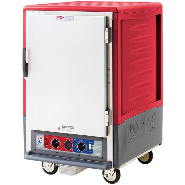 A red and grey Metro C5 heated holding and proofing cabinet with wheels.