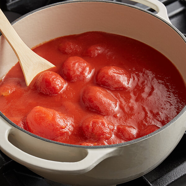 A pot of Conte whole peeled plum tomatoes in puree with a wooden spoon.