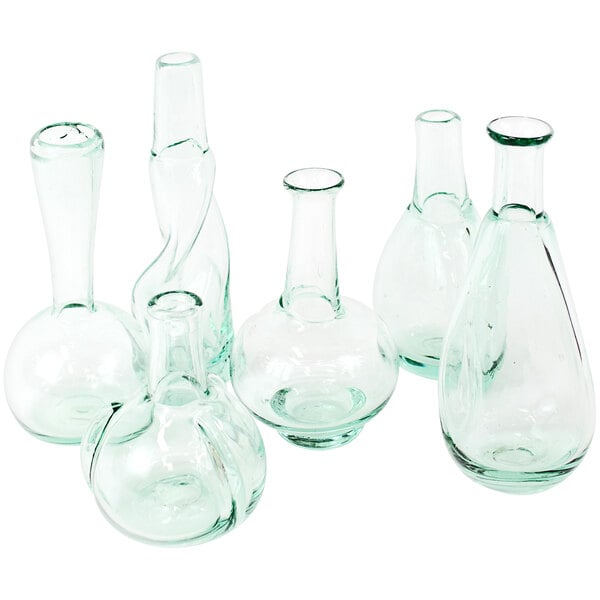 A group of six clear glass curved vases.