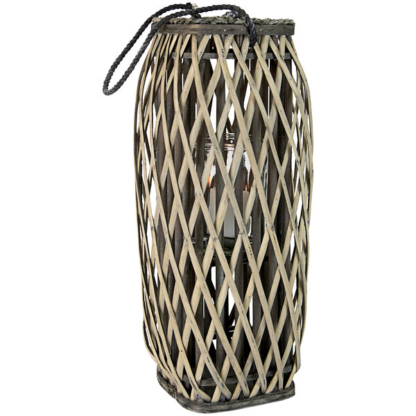 A Kalalou wicker lantern with a glass shade.