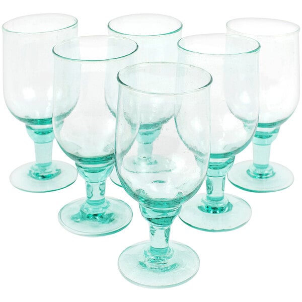 A case of six green recycled glass goblets with white rims.