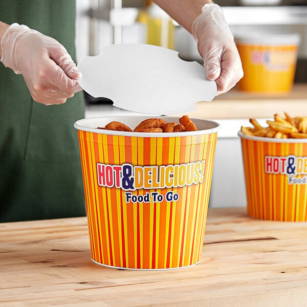 A person putting food into a Choice hot food bucket.