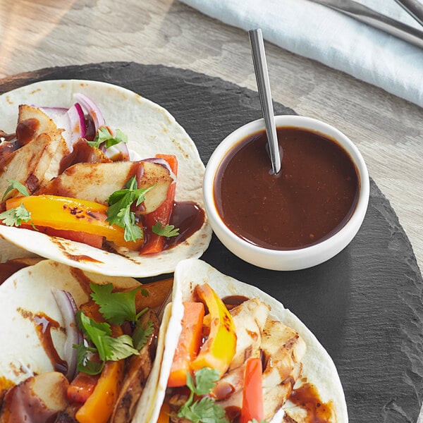 A plate of tacos with Knorr Fajita Sauce and vegetables.