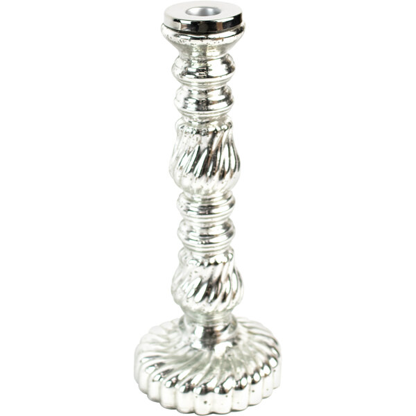 An antique silver Kalalou glass taper candle holder with a spiral design holding a candle.